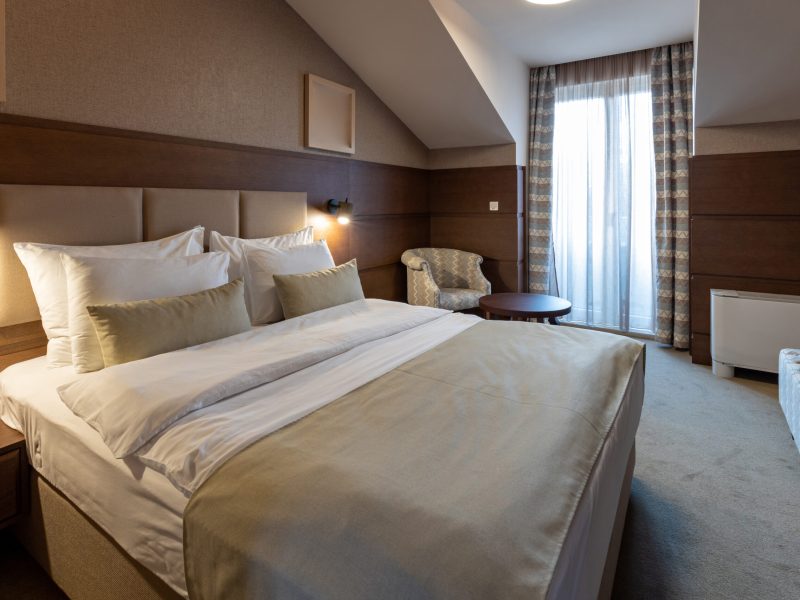 Interior of an empty luxury hotel double bed bedroom in the morning